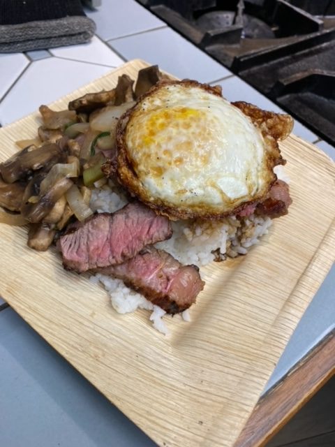 Hawaiian breakfast fried egg, tri-tip with onion and mushroom over white rice